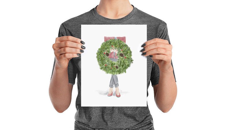May include: A watercolor illustration of a person wearing a red sweater and jeans with a green Christmas wreath around their head. The person is standing with their arms at their sides.
