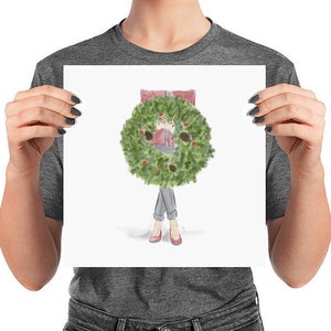 May include: A watercolor illustration of a person holding a green Christmas wreath in front of their body. The wreath is decorated with red berries and pine cones. The person is wearing a red sweater and blue jeans.