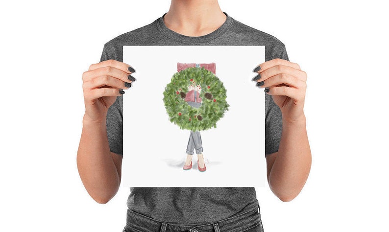 May include: A watercolor illustration of a person holding a green Christmas wreath in front of their body. The wreath is decorated with red berries and pine cones. The person is wearing a red sweater and blue jeans.
