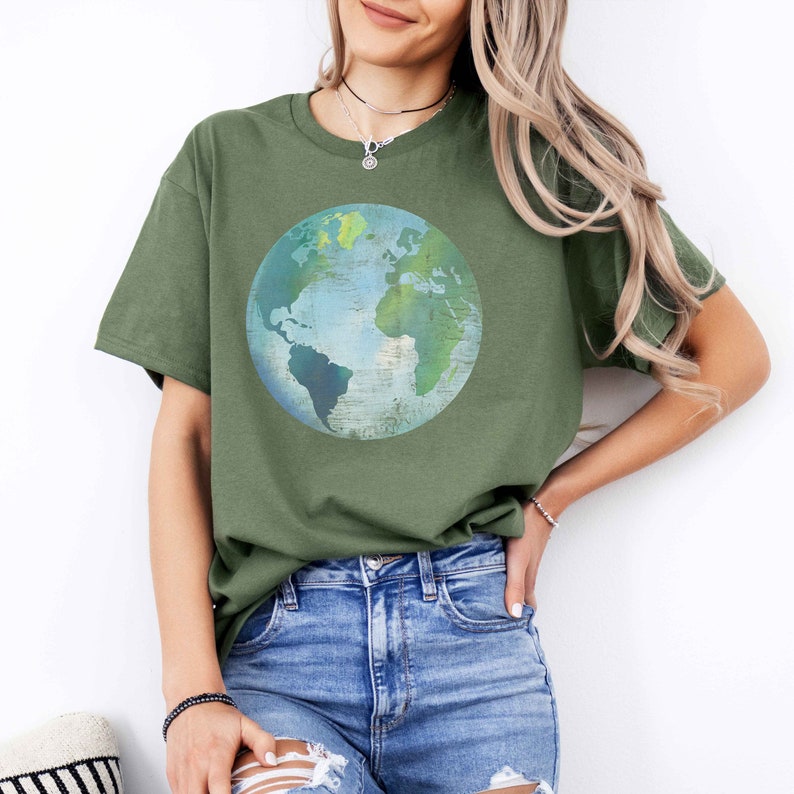 May include: A green t-shirt with a blue and green watercolor-style globe graphic.