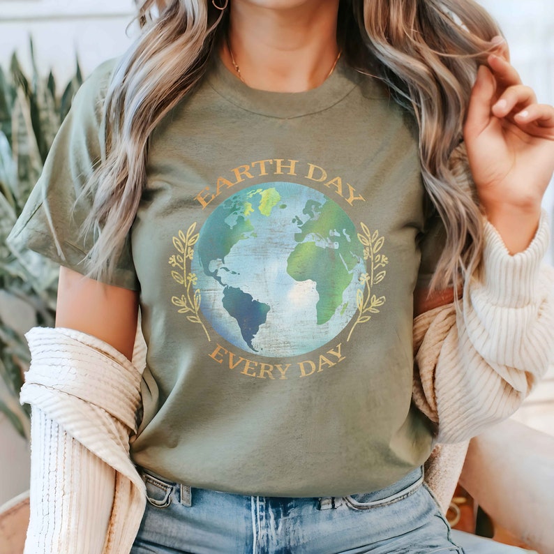 May include: A green t-shirt with a graphic of the Earth and the text "Earth Day Every Day" in gold lettering.