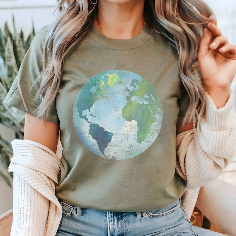 May include: A green t-shirt with a blue and green watercolor-style image of the Earth.