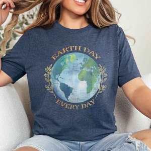 May include: A navy blue t-shirt with a graphic of a blue and green earth with the text "Earth Day Every Day" in gold lettering.