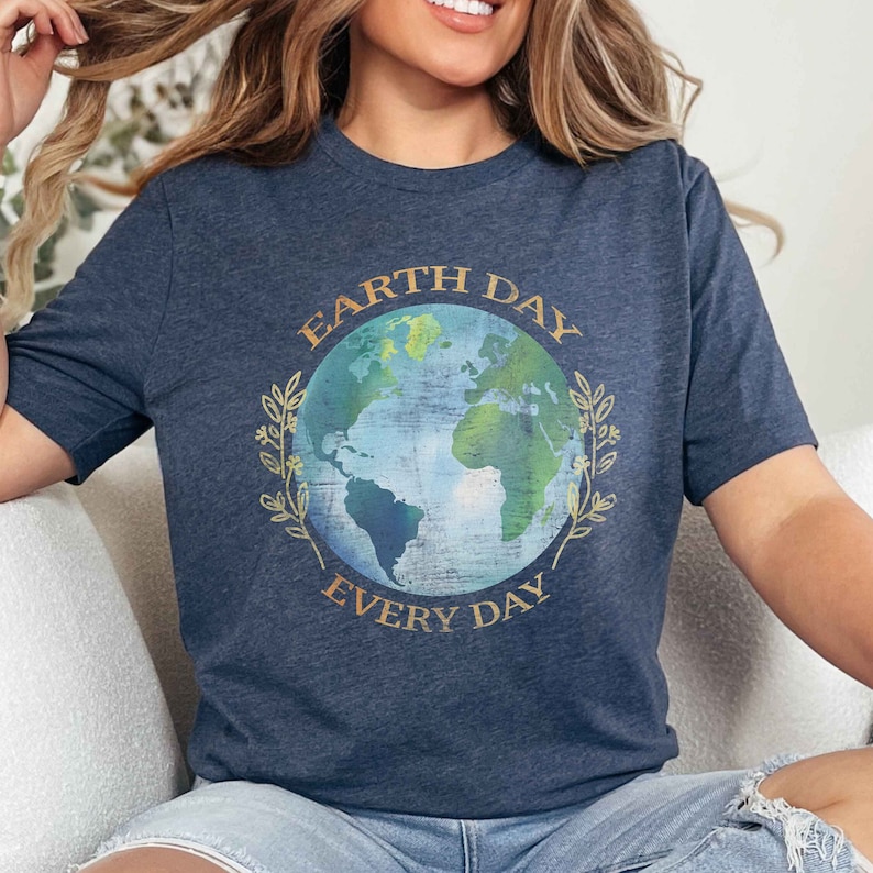 May include: A navy blue t-shirt with a graphic of a blue and green earth with the text "Earth Day Every Day" in gold lettering.