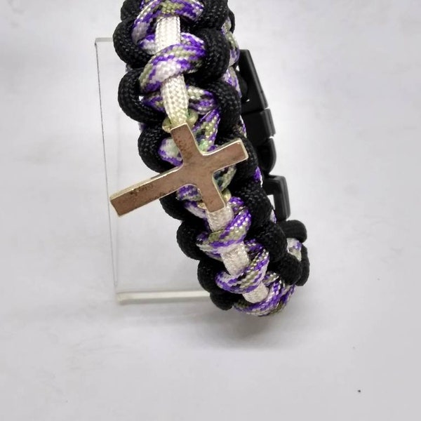 Splash some purple on your wrist. This  cross pendant goes well with anything.
