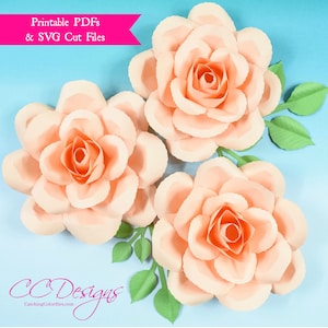Puede incluir: Tres rosas de papel de color melocotón con hojas verdes. Ficheros PDF imprimibles y archivos de corte SVG. CC Designs CatchingColorflies.com