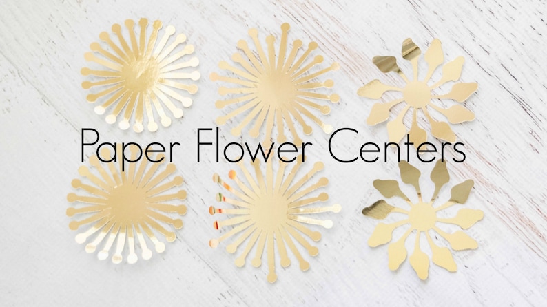 May include: Six gold paper flower centers, each with a different design. The centers are arranged on a white wooden surface. The text "Paper Flower Centers" is written in black below the centers.