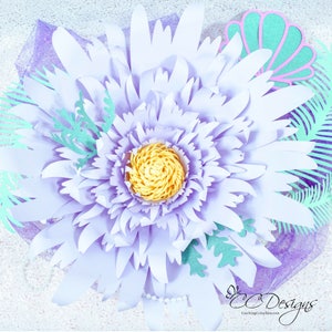 May include: A large, lavender paper flower with a yellow center. The flower is surrounded by green paper leaves and a seashell.