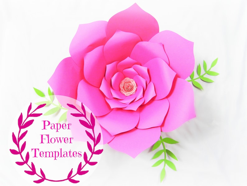 May include: A large pink paper flower with green leaves. The flower is made of multiple layers of paper and has a center that is also made of paper. The text "Paper Flower Templates" is written in a circle around the flower.