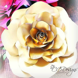 May include: A large, golden paper rose with multiple layers of petals. The rose is a decorative element for a wedding, party, or other special event.