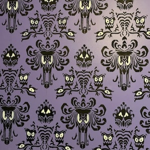 May include: Purple wallpaper with a repeating pattern of black and white ghosts. The ghosts have large eyes and a menacing expression. The wallpaper is a popular design for Halloween decorations.