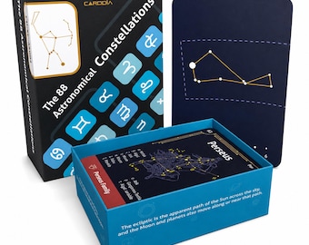 May include: A Cardoia educational card set titled The 88 Astronomical Constellations. The black box features blue zodiac symbols. Inside, a blue box holds cards, including one labeled Perseus with star charts and text about the ecliptic path.