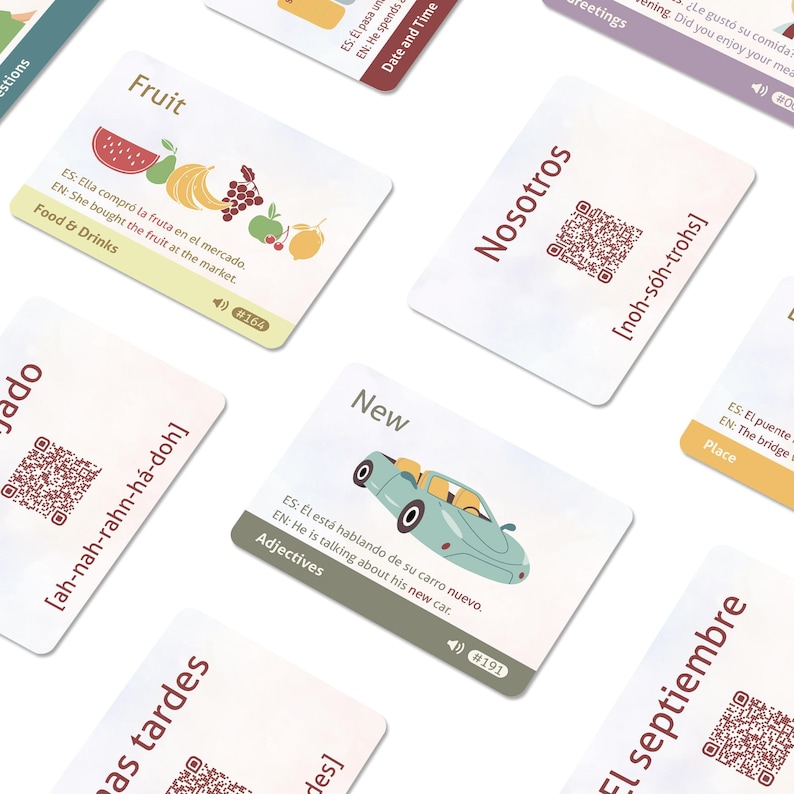 May include: A collection of rectangular educational language learning cards featuring illustrations, Spanish and English text, QR codes, and phonetic pronunciations. Each card displays a specific category label, such as Food & Drinks or Adjectives.