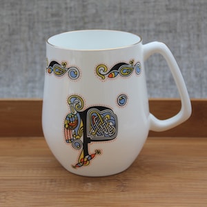 Ireland porcelain cup, Royal Tara, fine bone China/white, with golden flourishes/Celtic inspired cup and Kells book design