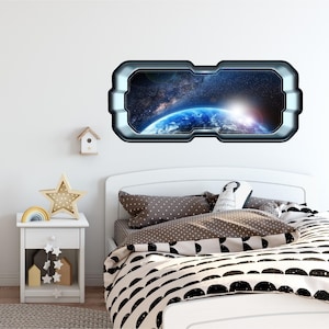 May include: A white bed with a black and white patterned duvet cover and a space-themed window sticker on the wall behind it. The sticker features a view of Earth from space with a sunrise in the background.