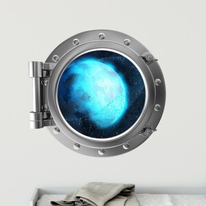 May include: A round, silver porthole with a view of a blue planet in space. The porthole is set against a white wall.