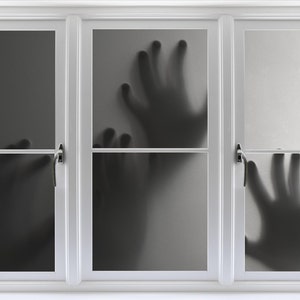 May include: A white window with three panes.  Each pane has a frosted glass surface with a shadowy handprint on it.