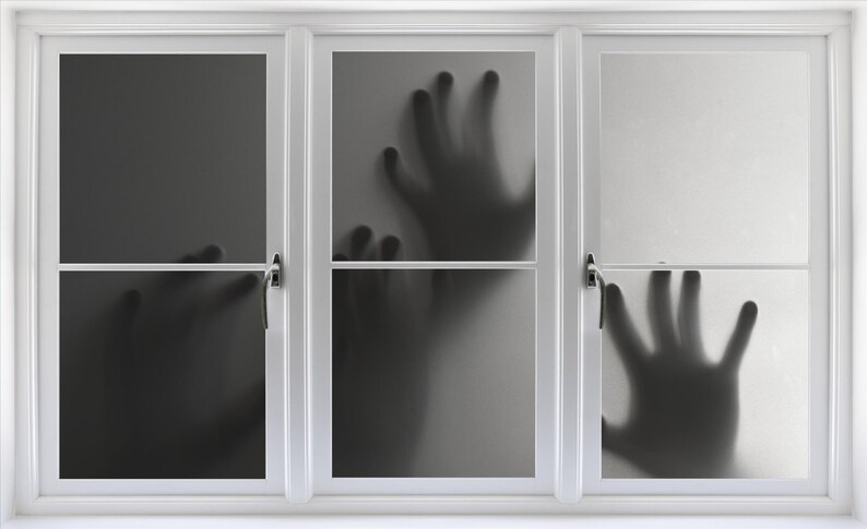 May include: A white window with three panes.  Each pane has a frosted glass surface with a shadowy handprint on it.