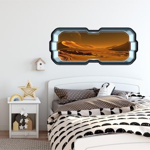 May include: A white bed with a black and white patterned duvet cover and a gray pillow with a white doll design. A white nightstand with a drawer and a shelf is next to the bed. A rainbow-colored arch and a white star-shaped nightlight are on the nightstand. A white birdhouse is on the wall behind the bed. A large, rectangular, silver-framed window sticker with a view of a red, rocky, alien landscape is on the wall above the bed.