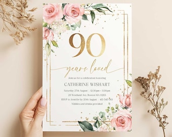 May include: A white invitation card with a gold border and floral design. The text on the card reads "90 years loved" and includes details for a celebration honoring Catherine Wishart.