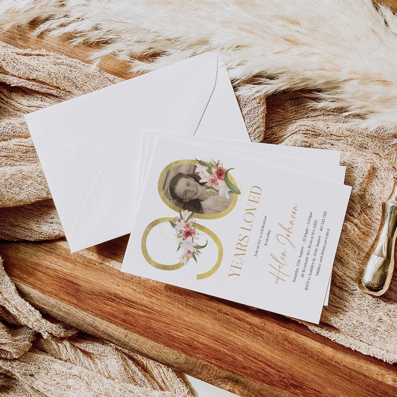 May include: A white card with gold lettering and a floral design. The card says "90 Years Loved" and "Helen Johnson". There is a photo of a woman in the corner of the card.