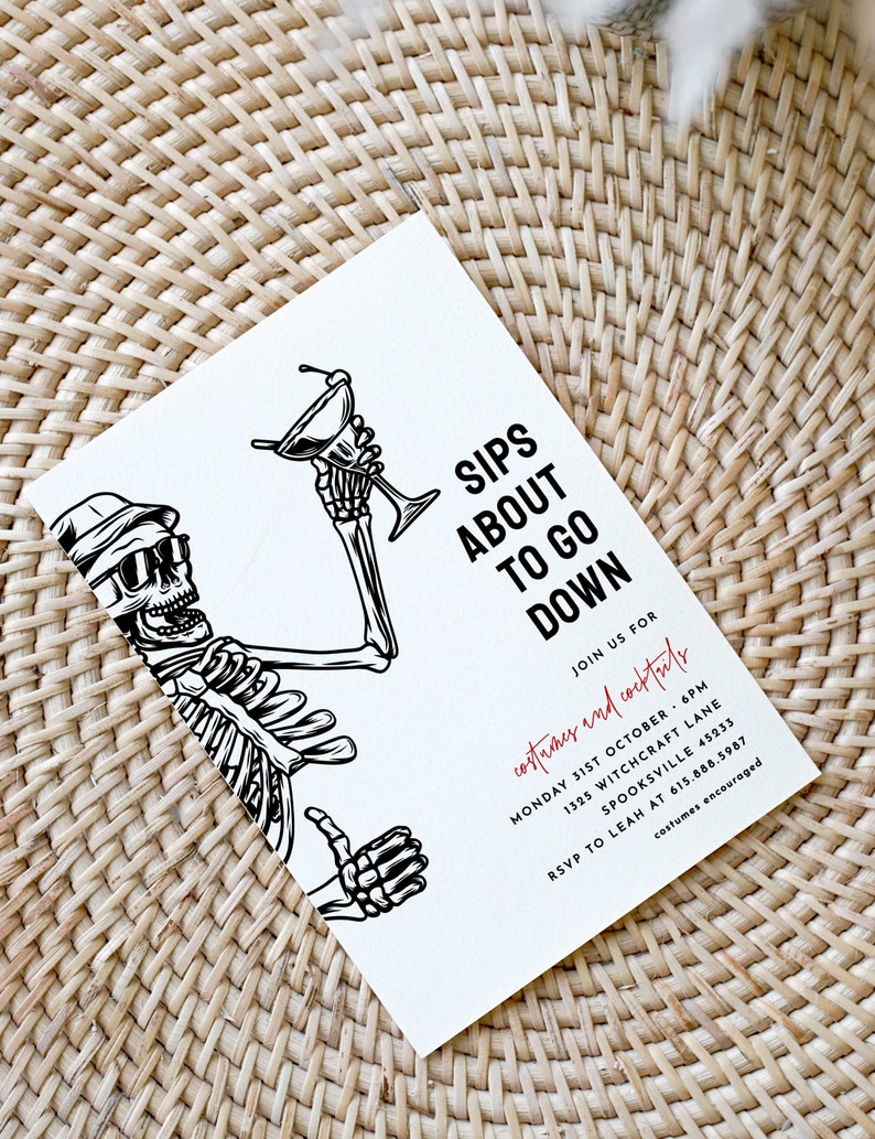 May include: A black and white illustration of a skeleton holding a martini glass. The text "Sips About To Go Down" is written in black. The text "Join us for costumes and cocktails" is written in red. The text "Monday 31st October 6pm" is written in black. The text "1325 Witchcraft Lane" is written in black. The text "Spooksville 45233" is written in black. The text "RSVP to Leah at 615.588.5987" is written in black. The text "costumes encouraged" is written in red.