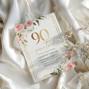 May include: A gold and white invitation card with a floral design and gold lettering. The text reads "90 years loved" and "Join us for a celebration honoring Catherine Wishart".