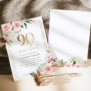 May include: A gold and white invitation with pink floral accents. The invitation reads "90 years loved" and includes details for a celebration honoring Catherine Wishart.