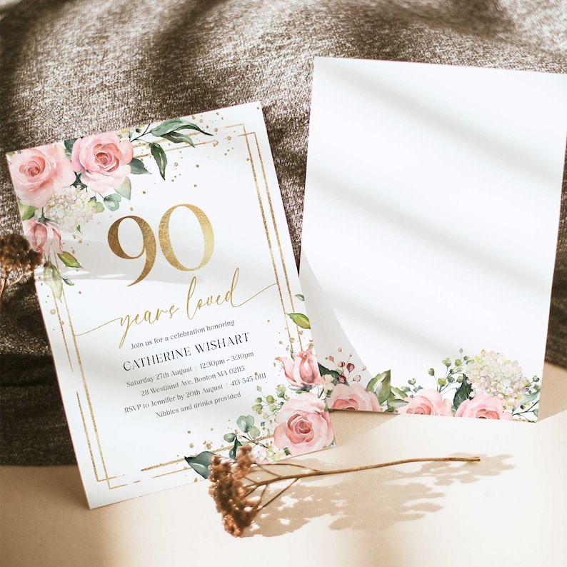 May include: A gold and white invitation with pink floral accents. The invitation reads "90 years loved" and includes details for a celebration honoring Catherine Wishart.