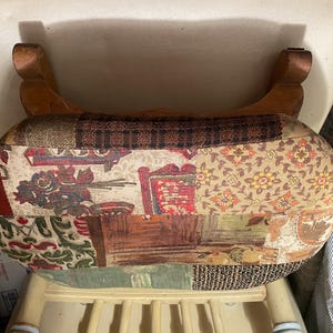 May include: A patchwork fabric footstool with a wooden frame. The fabric is a mix of floral, geometric, and paisley patterns in shades of brown, red, green, and beige.