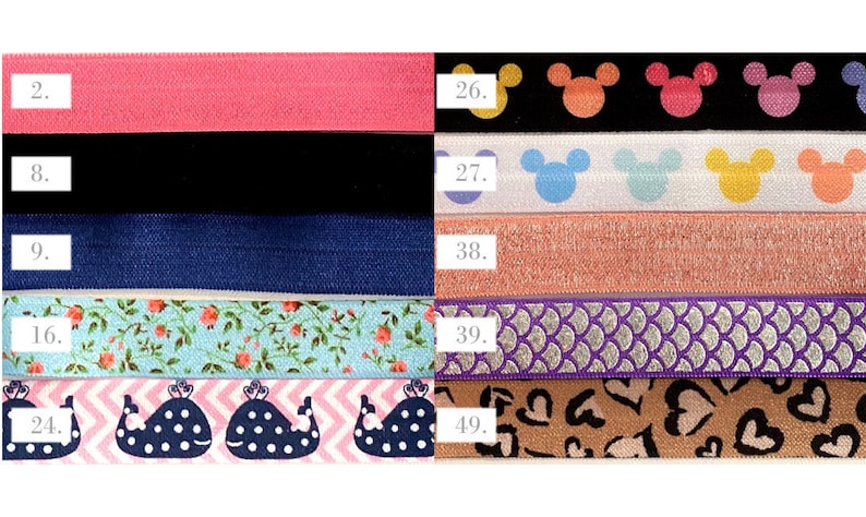 May include: A set of ten colorful elastic hair ties with different patterns, including pink, black, blue, floral, whale, Mickey Mouse, glitter, and hearts. The numbers 2, 8, 9, 16, 24, 26, 27, 38, 39, and 49 are printed on the elastic bands.