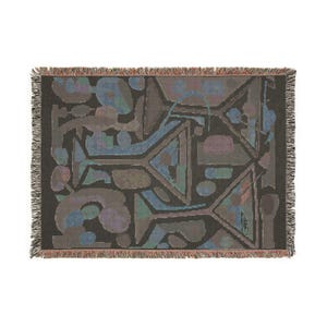 May include: A rectangular woven throw blanket featuring a dark charcoal background with an abstract pattern of martini glasses in muted shades of blue, purple, and green. The edges of the blanket are finished with a decorative fringed border.