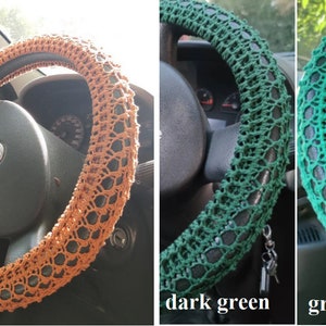 May include: Three crocheted steering wheel covers in different colors: ginger, dark green, and green 015. The covers are made of a delicate, open-weave pattern.