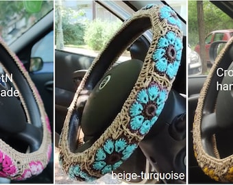 May include: Three crocheted steering wheel covers in beige, pink, turquoise, and yellow. The covers are handmade and feature a floral design. The text "CroshetN handmade" is visible on two of the covers.
