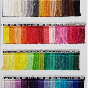 May include: A color chart of 100% cotton fringe yarn in various colors. The chart is labeled with the color name and a corresponding number for each color. The chart is divided into four rows, each row labeled with a letter from a to d. The chart is labeled "Tango" at the top.