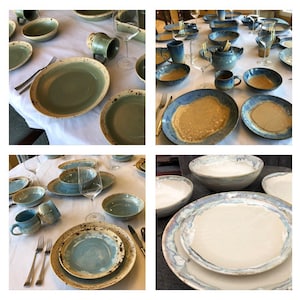 May include: A collection of ceramic plates and bowls in various shades of blue and green with speckled glaze. The plates and bowls are arranged on a white tablecloth.
