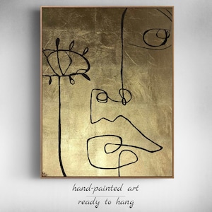 May include: Abstract line art painting on a gold background. The painting features a stylized face with a single eye and a flower.