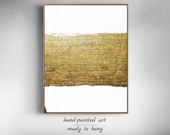 May include: Abstract painting with a horizontal band of gold paint on a white background. The gold paint has a textured, metallic look.