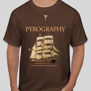 May include: A brown t-shirt with the text "PYROGRAPHY" and a vintage illustration of a sailing ship. The text "www.Etsy.com/shop/trevorhopepyrography" is printed below the ship.