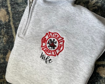 May include: Gray sweatshirt with a red and black embroidered fire department logo and the word "Wife" underneath.