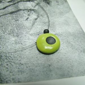 Ceramic necklace green and black raku.