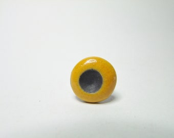 Yellow and black raku ceramic ring.