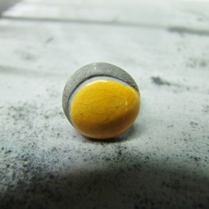 Adjustable yellow and black ceramic ring.