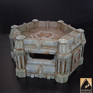 May include: A hexagonal, gray and brown, 3D printed, miniature castle tower with a detailed interior and a small, open doorway.