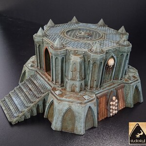 May include: A detailed, gray, and green, 3D printed, gothic-style tower with a skull and bones decoration. The tower has a grated roof, a set of stairs leading up to the entrance, and a door with a skull and bones design.