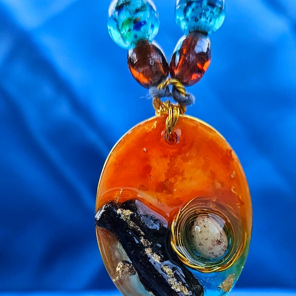 1 of a kind Hand-poured Epoxy Resin Pendant. Wood knot, wire, plastic egg, glass beads, gold flecks, natural hemp cord, toggle clasp "Nest"