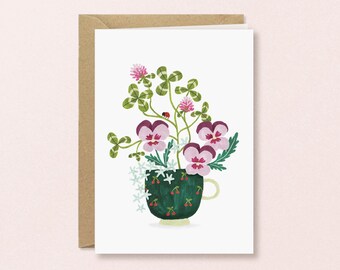 Cup of Pansies Greeting Card | Enchanting handmade illustration of pansies and clover growing from a teacup