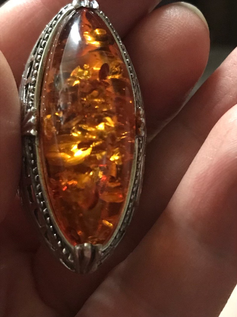 hallmarked 925 silver ring with  genuine Royal  amber hand carved stone