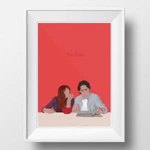 May include: Framed art print with a minimalist illustration of two people at a table. The artwork has a red background with the text "Ruby Sparks". The figures are depicted in a simplified style, with a bowl and newspaper on the table.