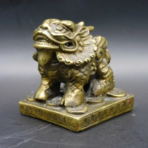 Chinese Antique Foo Dogs sitting on coins